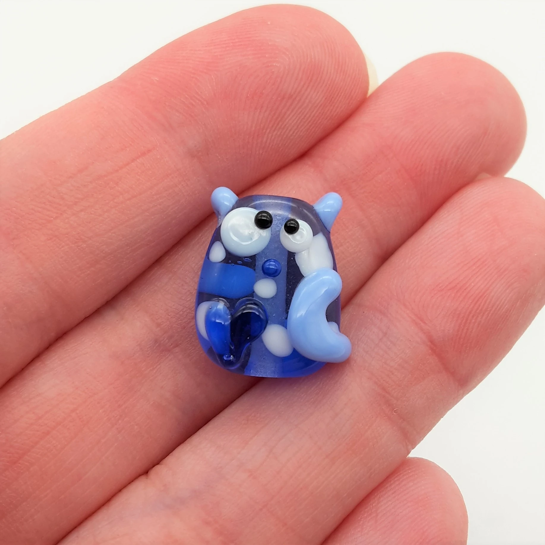 Lampwork glass bead in blues and whites.