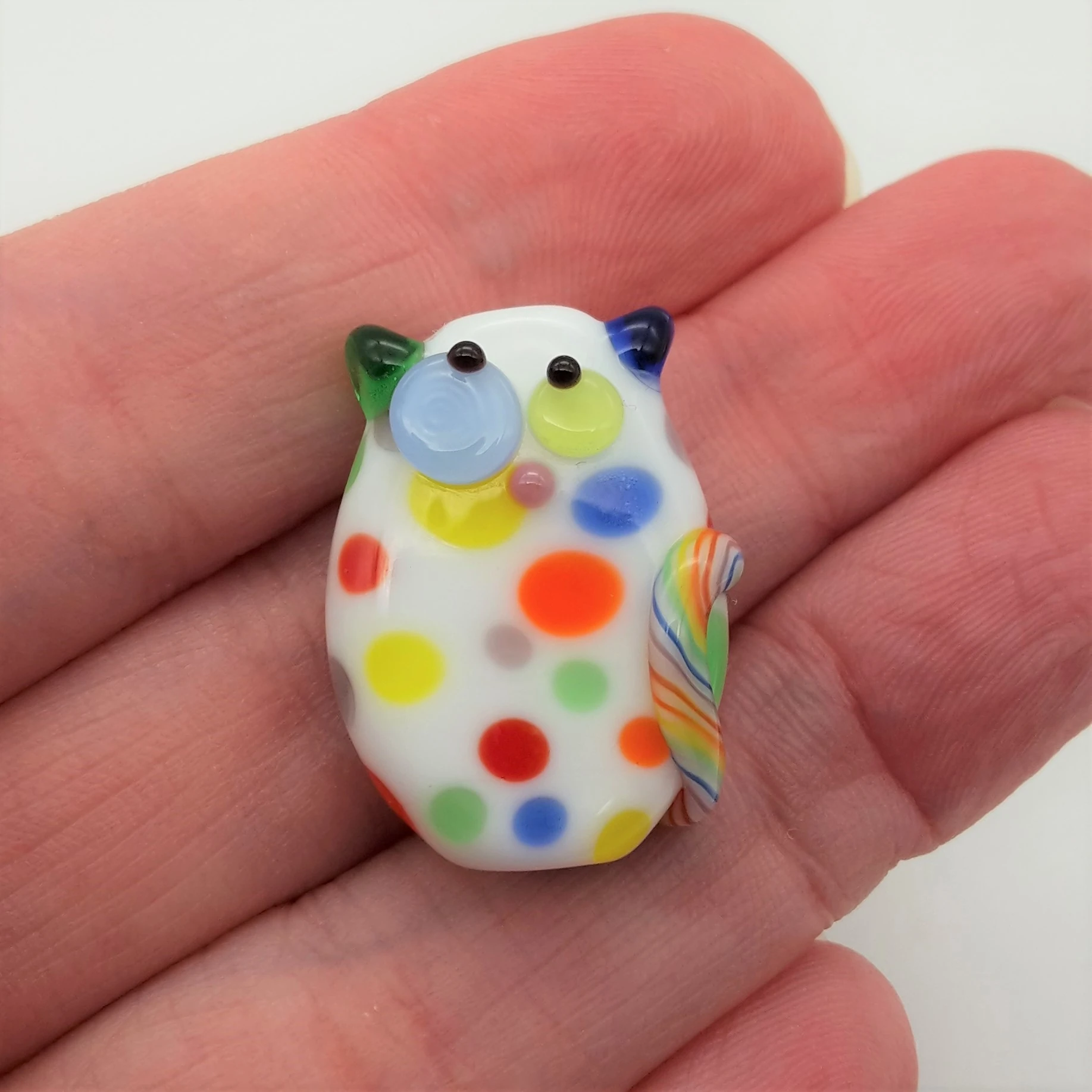 Lampwork glass bead cat with confetti dots and kooky eyes.
