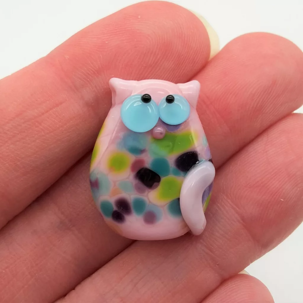 Lampwork glass bead cat with fritty spots.
