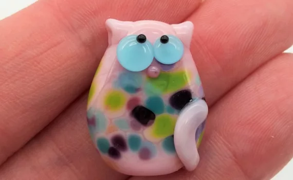 Lampwork glass bead cat with fritty spots.