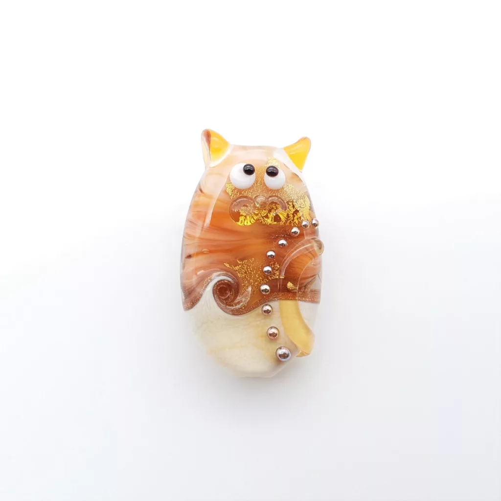Lampwork glass bead cat in caramel amber swirls and striations. Golden pearls and flecks.